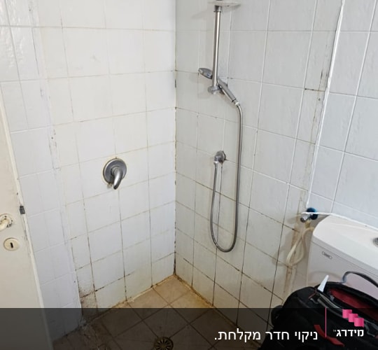 shower area with visible dirt and mold on tiles